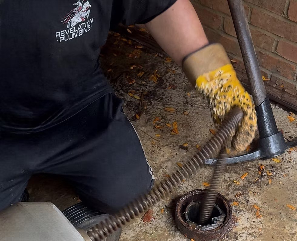 Drain-cleaning cable fed into an access opening