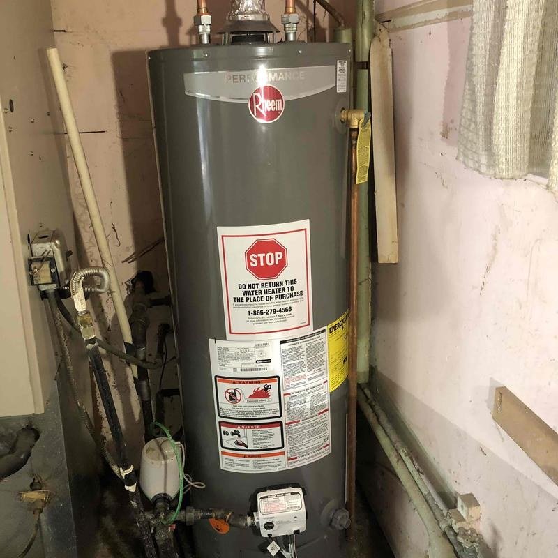 Single Rheem gas water heater in a utility area
